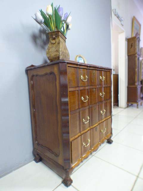 An exquisite vintage Imbuia 4-drawer chest of drawers with ornate handles and ample storage space