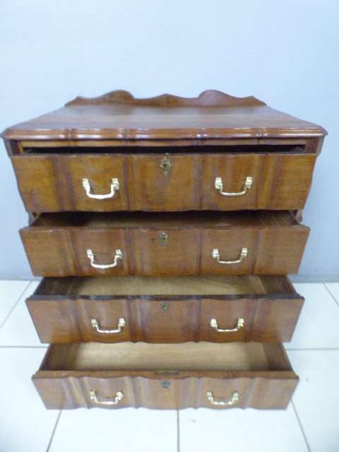 An exquisite vintage Imbuia 4-drawer chest of drawers with ornate handles and ample storage space