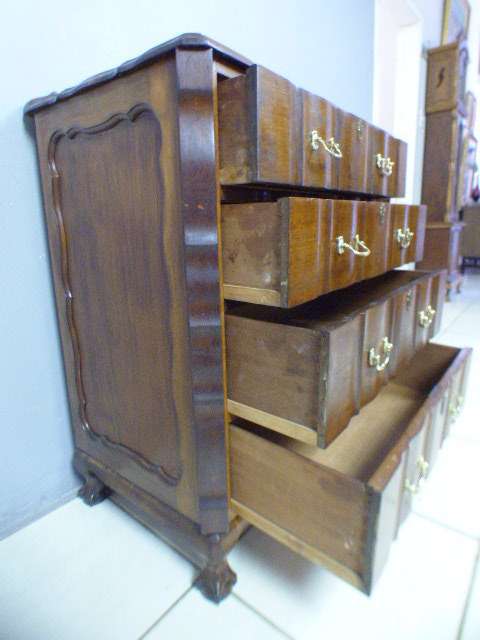 An exquisite vintage Imbuia 4-drawer chest of drawers with ornate handles and ample storage space