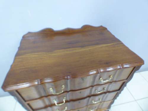 An exquisite vintage Imbuia 4-drawer chest of drawers with ornate handles and ample storage space