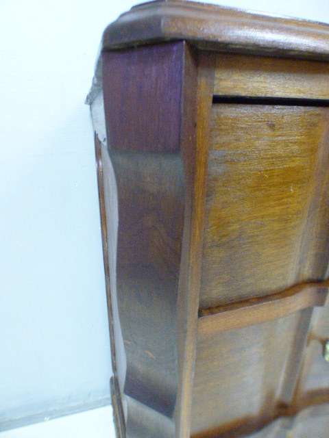 An exquisite vintage Imbuia 4-drawer chest of drawers with ornate handles and ample storage space