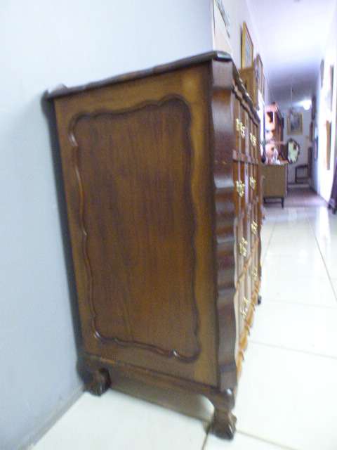 An exquisite vintage Imbuia 4-drawer chest of drawers with ornate handles and ample storage space