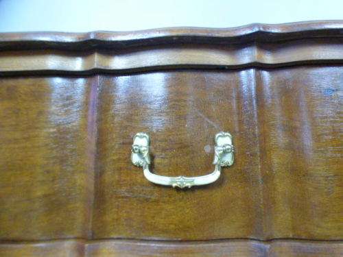 An exquisite vintage Imbuia 4-drawer chest of drawers with ornate handles and ample storage space