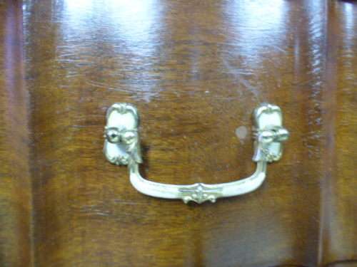 An exquisite vintage Imbuia 4-drawer chest of drawers with ornate handles and ample storage space