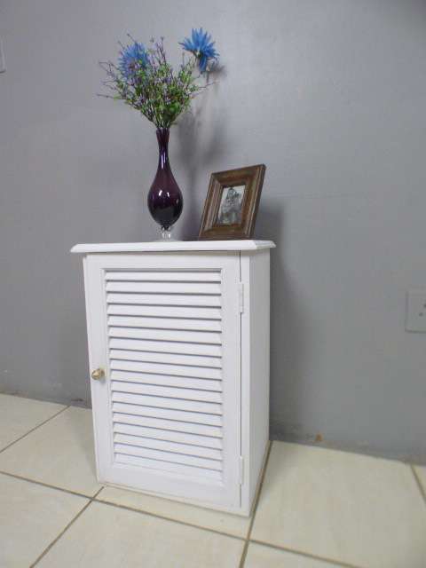 A stylish painted white pedestal w/ slatted door & large shelved cupboard. Lovely in all rooms!!