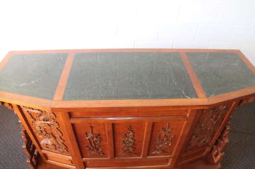 An extraordinary solid teak compact bar unit with solid green marble top and carved detailing