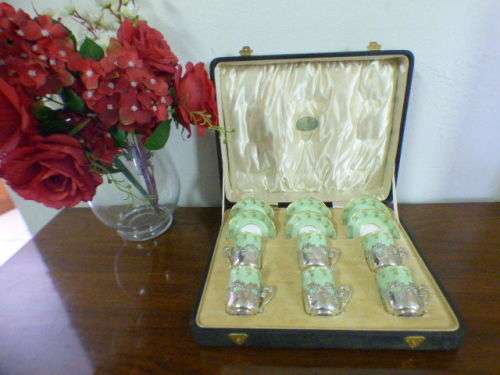 Magnificent boxed antique Royal Worcester demitasse duo's with gold detailing in silver cup holders!