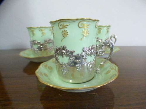 Magnificent boxed antique Royal Worcester demitasse duo's with gold detailing in silver cup holders!