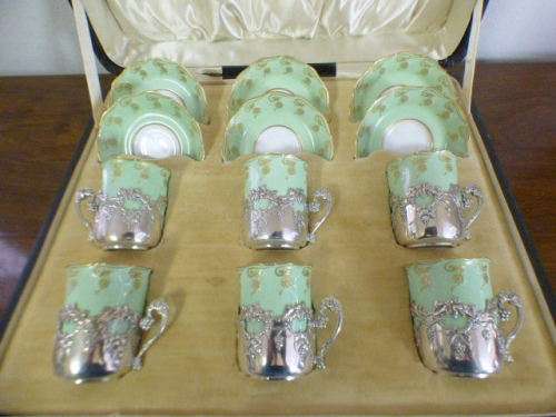 Magnificent boxed antique Royal Worcester demitasse duo's with gold detailing in silver cup holders!