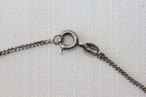 A stunning sterling silver (925) chain with a locket pendant and ornate detailing made in Italy