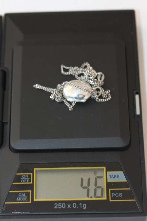 A stunning sterling silver (925) chain with a locket pendant and ornate detailing made in Italy