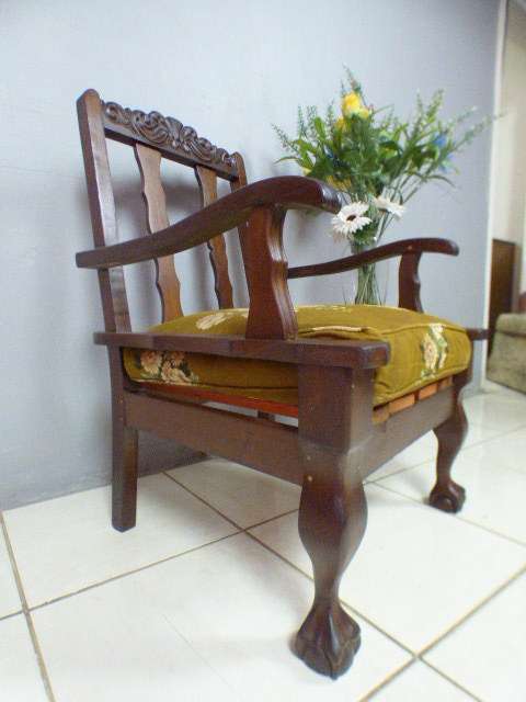 A gorgeous vintage Imbuia ball and claw hand carved arm chair, perfect in a sun room, patio, porch!!