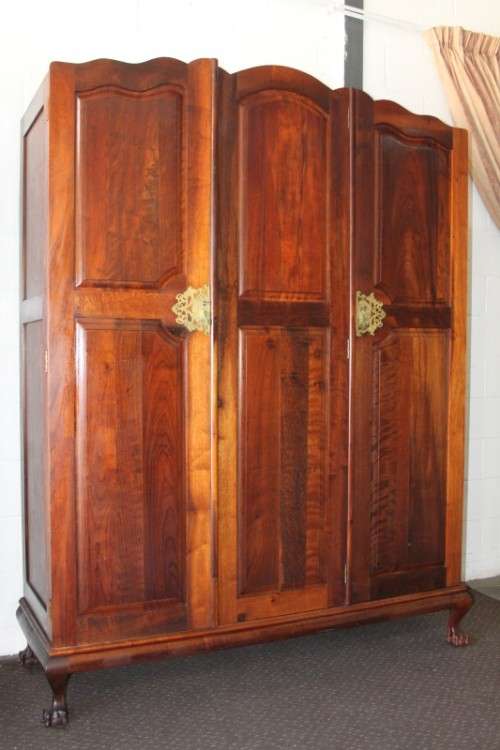 An incredible three-door solid Imbuia ball & claw wardrobe w/ solid brass embellishments