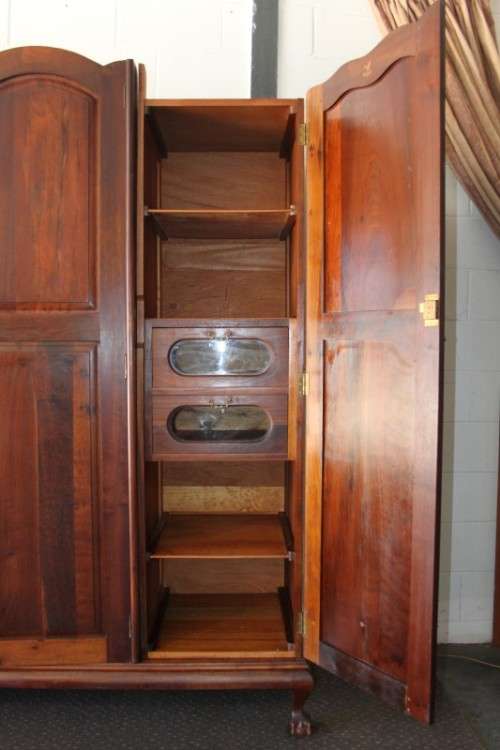 An incredible three-door solid Imbuia ball & claw wardrobe w/ solid brass embellishments