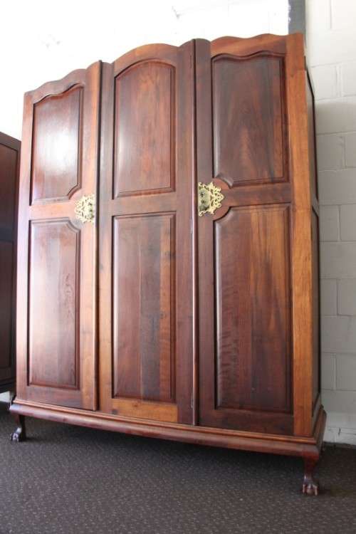 An incredible three-door solid Imbuia ball & claw wardrobe w/ solid brass embellishments