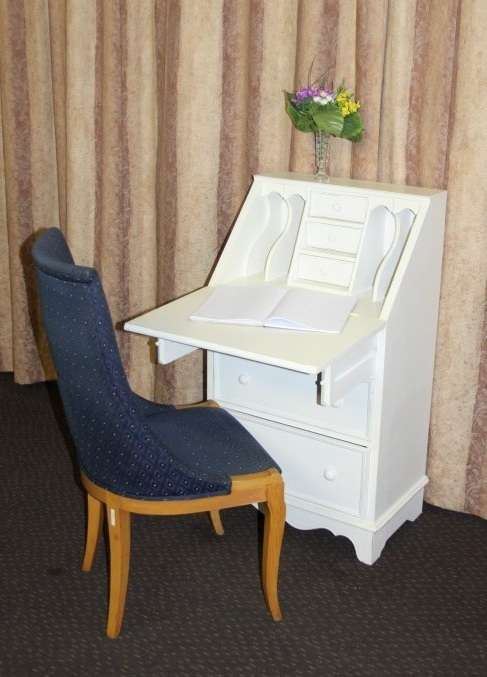 A stunning "eggshell" white flip-top writing desk with three large drawers and three smalls drawers