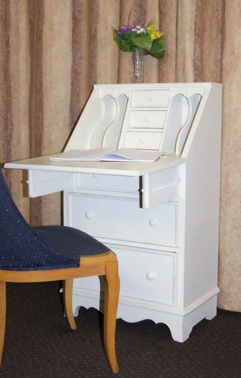 A stunning "eggshell" white flip-top writing desk with three large drawers and three smalls drawers