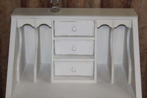 A stunning "eggshell" white flip-top writing desk with three large drawers and three smalls drawers