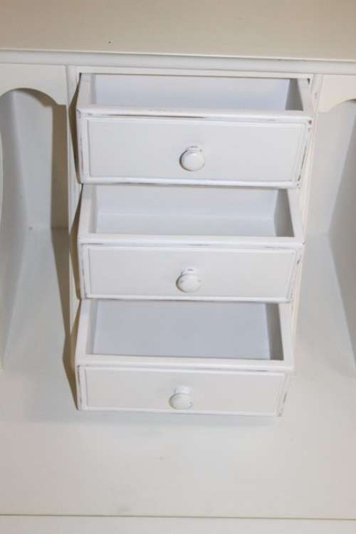 A stunning "eggshell" white flip-top writing desk with three large drawers and three smalls drawers