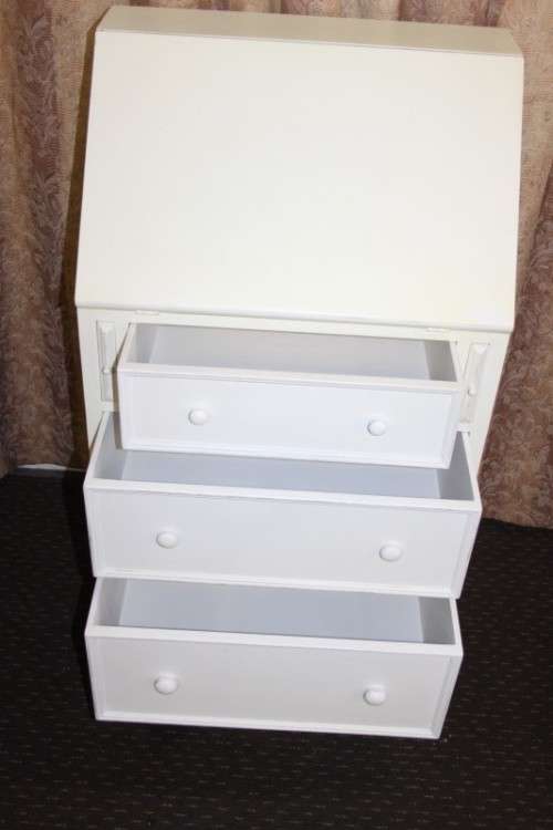 A stunning "eggshell" white flip-top writing desk with three large drawers and three smalls drawers