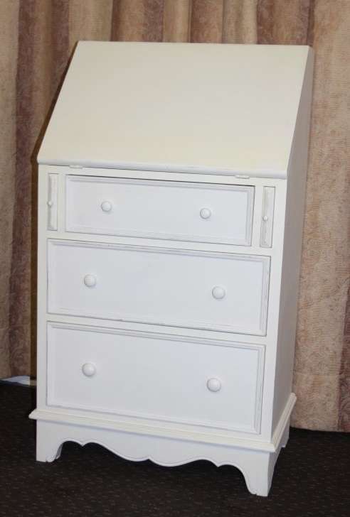 A stunning "eggshell" white flip-top writing desk with three large drawers and three smalls drawers
