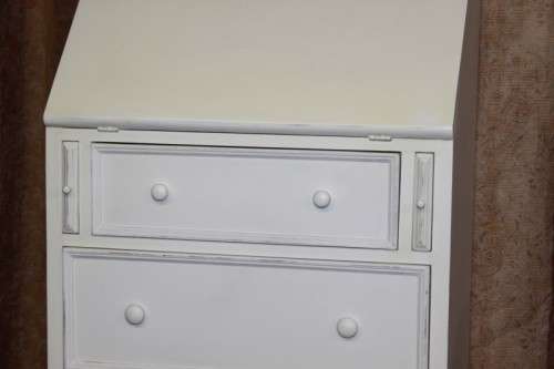 A stunning "eggshell" white flip-top writing desk with three large drawers and three smalls drawers