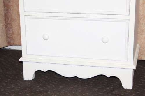 A stunning "eggshell" white flip-top writing desk with three large drawers and three smalls drawers