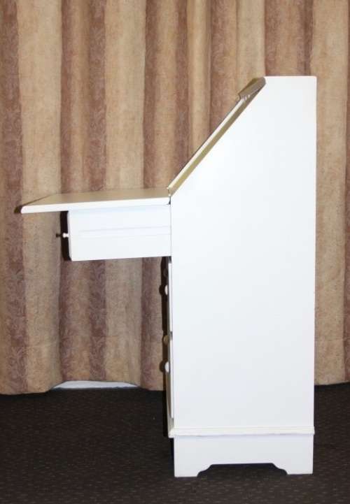 A stunning "eggshell" white flip-top writing desk with three large drawers and three smalls drawers