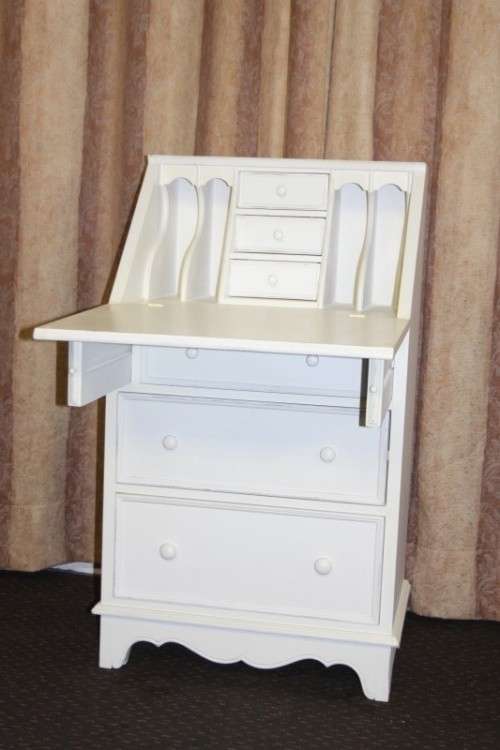 A stunning "eggshell" white flip-top writing desk with three large drawers and three smalls drawers
