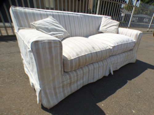 A stunning large modern styled slip covered couch in great condition. Perfect in informal lounges!