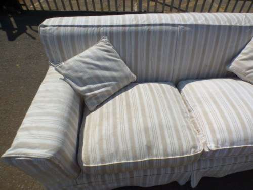 A stunning large modern styled slip covered couch in great condition. Perfect in informal lounges!