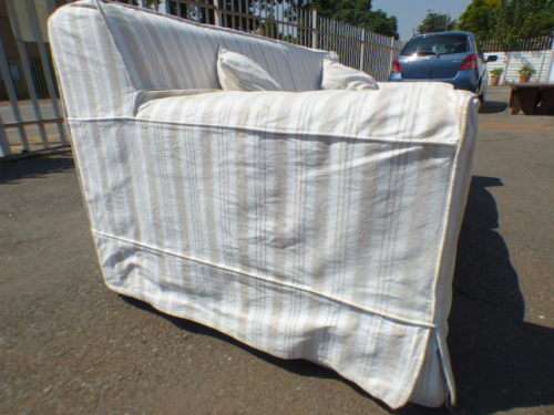 A stunning large modern styled slip covered couch in great condition. Perfect in informal lounges!