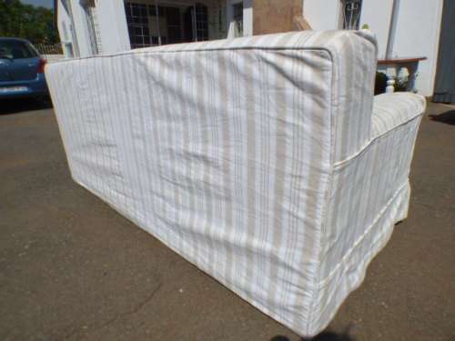 A stunning large modern styled slip covered couch in great condition. Perfect in informal lounges!