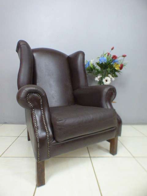 An exquisite LGE genuine leather studded wing back chair.  Perfect in an executive office.