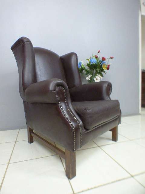An exquisite LGE genuine leather studded wing back chair.  Perfect in an executive office.