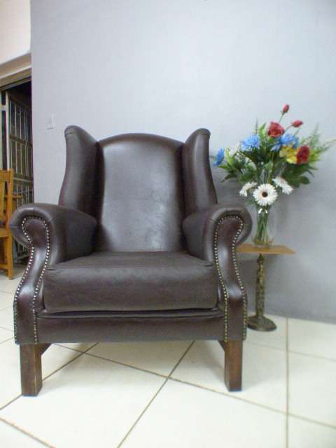 An exquisite LGE genuine leather studded wing back chair.  Perfect in an executive office.