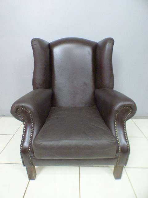An exquisite LGE genuine leather studded wing back chair.  Perfect in an executive office.