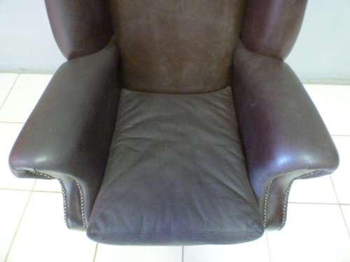 An exquisite LGE genuine leather studded wing back chair.  Perfect in an executive office.