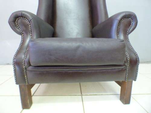 An exquisite LGE genuine leather studded wing back chair.  Perfect in an executive office.