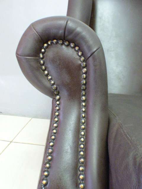 An exquisite LGE genuine leather studded wing back chair.  Perfect in an executive office.