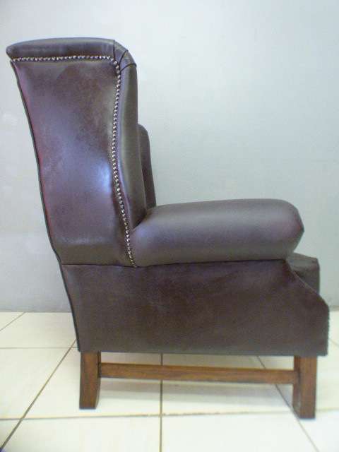 An exquisite LGE genuine leather studded wing back chair.  Perfect in an executive office.