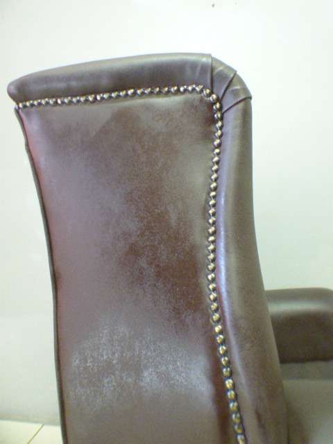 An exquisite LGE genuine leather studded wing back chair.  Perfect in an executive office.