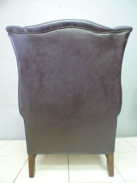 An exquisite LGE genuine leather studded wing back chair.  Perfect in an executive office.