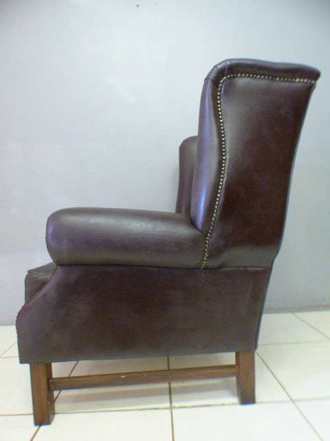 An exquisite LGE genuine leather studded wing back chair.  Perfect in an executive office.