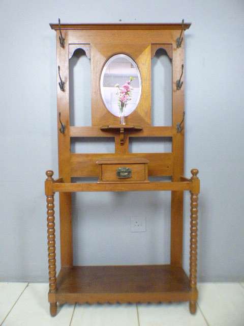 A stunning tall Teak hall stand with a beveled mirror, drawer and 6 hooks in great condition.