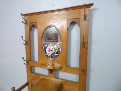 A stunning tall Teak hall stand with a beveled mirror, drawer and 6 hooks in great condition.