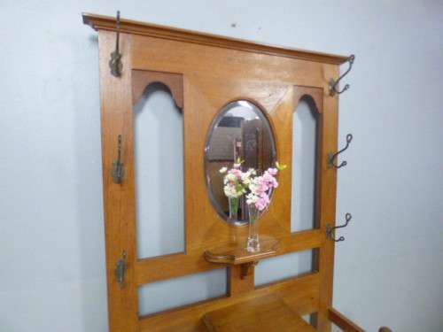 A stunning tall Teak hall stand with a beveled mirror, drawer and 6 hooks in great condition.