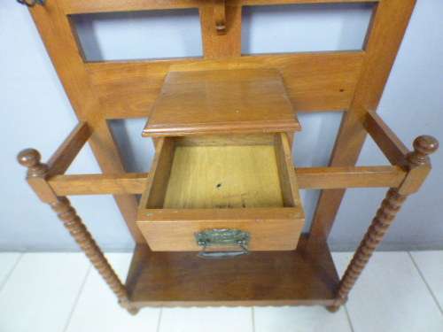 A stunning tall Teak hall stand with a beveled mirror, drawer and 6 hooks in great condition.