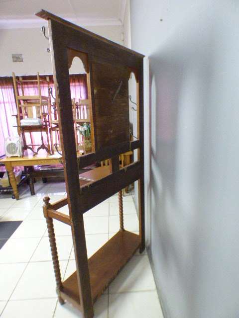 A stunning tall Teak hall stand with a beveled mirror, drawer and 6 hooks in great condition.