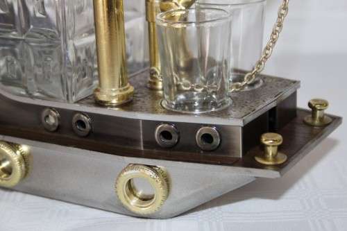 An amazing vintage tugboat decanter with a wind-up music box and four shot glasses